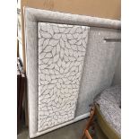An upholstered and padded double bed headboard