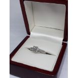 A hallmarked 18ct white gold diamond ring, the four central princess cut diamonds weighing approx.
