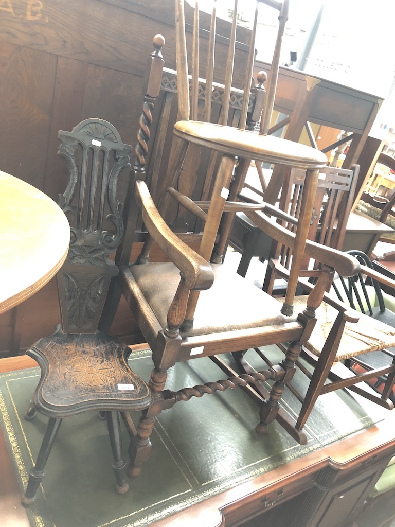 Three chairs comprising a spinning stool, an oak barley twist elbow chair and a spindle chair.