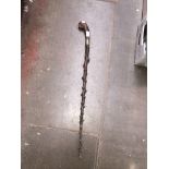 An antique knobstick with silver collar.