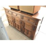 An oak sideboard with carved panels