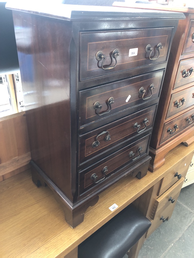 A reproduction mahogany small chest of drawers