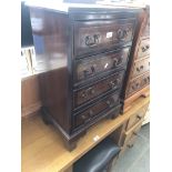 A reproduction mahogany small chest of drawers