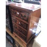 A reproduction yew wood small chest of drawers