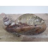 A contemporary Arts & Crafts rustic sculpture modelled as a fish on a rock and set and overlaid with
