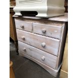 A modern stained pine chest of drawers