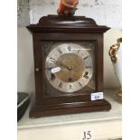 A reproduction burr walnut cased Elliot mantle clock with key.