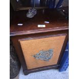 A pair of vintage wooden speakers with embroidered front.