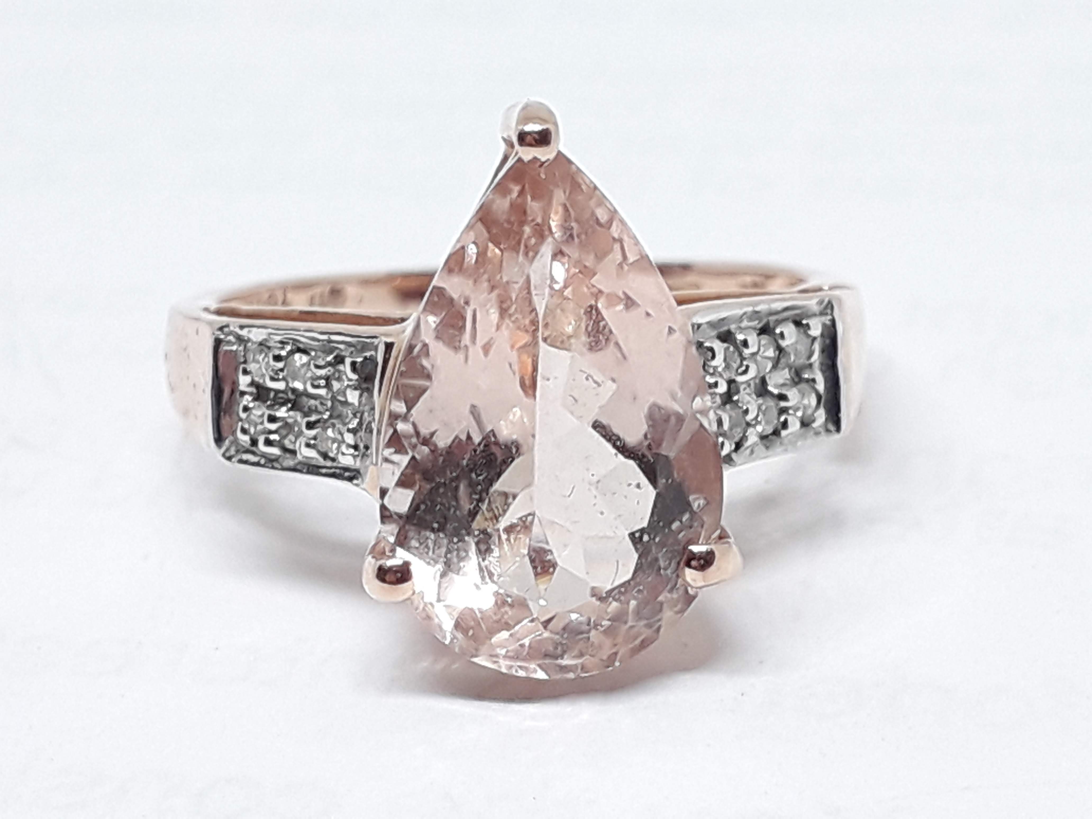 A hallmarked 9ct gold ring set with a pear cut pale peach/pink morganite, gross wt. 2.94g, size N.