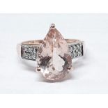 A hallmarked 9ct gold ring set with a pear cut pale peach/pink morganite, gross wt. 2.94g, size N.
