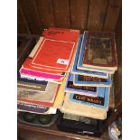A collection of vintage canvas OS maps and touring guide books.