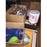 A large box of various items including glasses, Panini sticker albums, various electrical sockets,