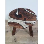 A contemporary Arts & Crafts rustic stool inlaid with cast hallmarked silver, approx. 1 kilo of
