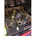 A box of brassware to include bells, candlesticks, etc.