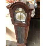 A reproduction granddaughter clock with weights and pendulum