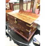 An Eastern hardwood and brass inlaid and bound chest