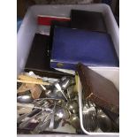 A box of boxed cutlery and loose cutlery