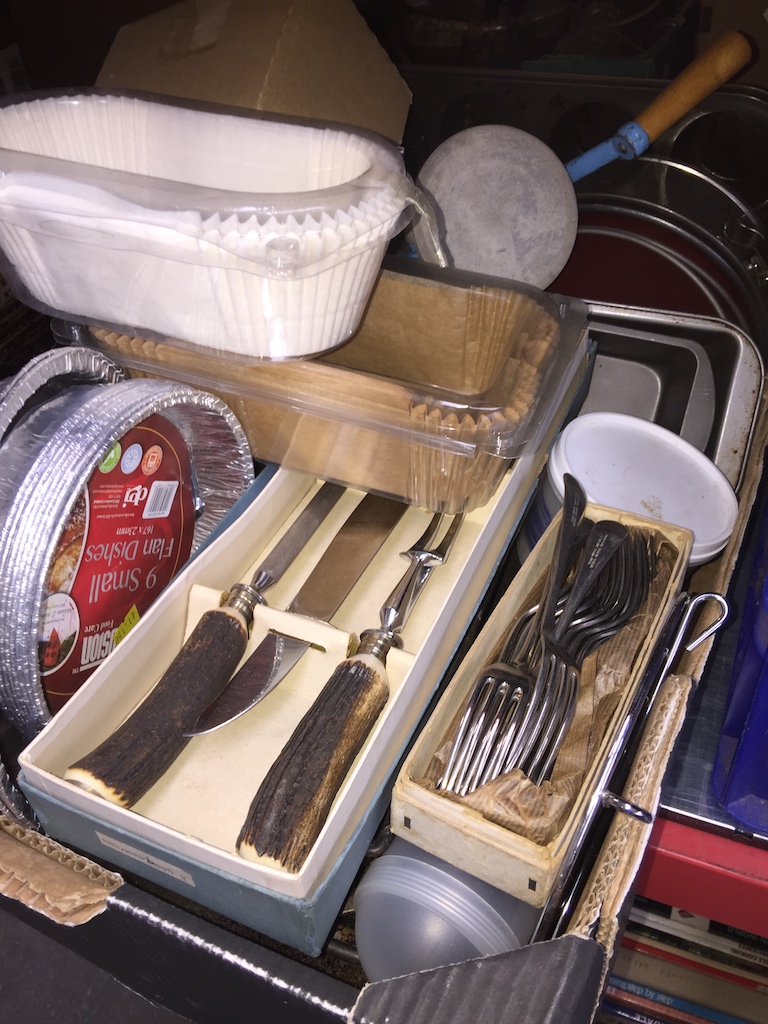 A box of kitchen ware, pots and pans, cutlery, etc.