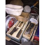 A box of kitchen ware, pots and pans, cutlery, etc.