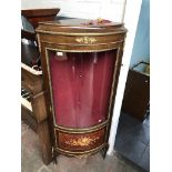 A reproduction continental glazed corner display cabinet with marquetry inlaid panel and gilt