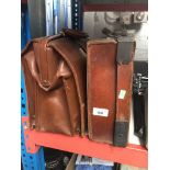 A leather briefcase and a small leather suitcase