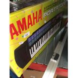 A Yamaha Portatone PSR-73 keyboard in original box.