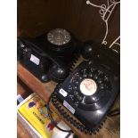 2 black bakelite telephones.