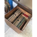 A wooden box containing old vinyl.