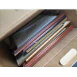 A box with quantity of pictures and picture frames.