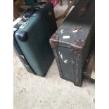 A large leather and canvas suitcase and a hard shell Revelation suitcase.