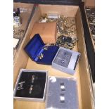 A collection of cufflinks, tie pins and other items