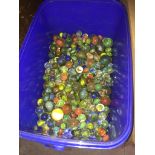 A blue tub of vintage marbles.