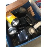 A box containing five vintage telephones and various torches.