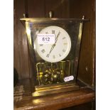 Brass revolving pendulum clock