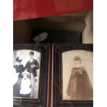 A box of vintage photograph albums and photographs.