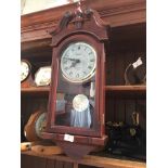 A Timemaster Westminster chime wall clock with pendulum, battery operated.