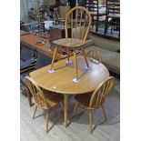 An Ercol light elm and beech drop leaf table and four chairs, height 72cm, width 113cm. Some light