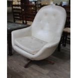 A retro cream coloured vinyl swivel chair, height 94cm, width 86cm, depth 75cm. Some signs of wear