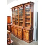 A Victorian mahogany breakfront bookcase, circa 1860, with cornice top, scroll supports and