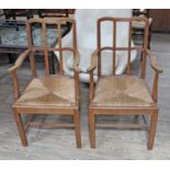 A pair of Cotswold School Arts & Crafts oak armchairs by Theo Dalrymple after a design by Gimson.