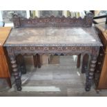 A Victorian carved oak side table, height 94cm, width 104cm and depth 43cm. There are some marks and