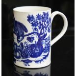 A Worcester porcelain mug, circa 1760 decorated with blue transfer depicting a bird above various