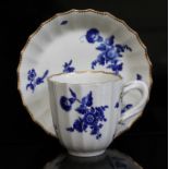 A Worcester coffee cup and saucer, circa 1760, of fluted form and decorated in over-glaze blue