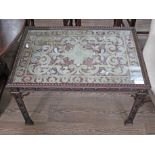 A Chippendale style occasional table with pierced fretwork and legs, having embroidered silk to