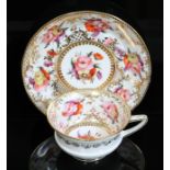 A Coalport porcelain tea cup and saucer, circa 1820, hand painted with floral sprays and gilt