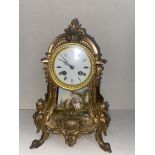 Late 19th century mantle clock, gilt metal with porcelain panel, missing finial and pendulum.