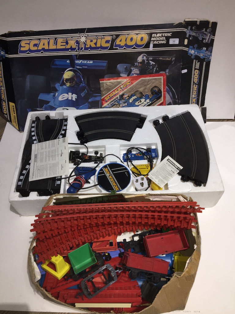 scalextric 400 set and a box containing a vintage plastic train set