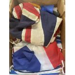 Box containing various flags including vintage Union Jack