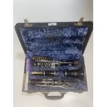 A vintage clarinet in case, marked 'THE BRITISH HI SPOT BAND INSTRUMENT CORP'