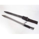 A WWI German butcher bayonet and scabbard.